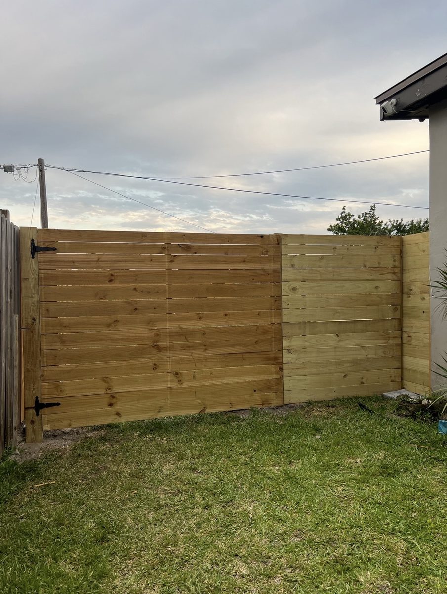 Horizontal wood fence and gate installed by Rodgers Services